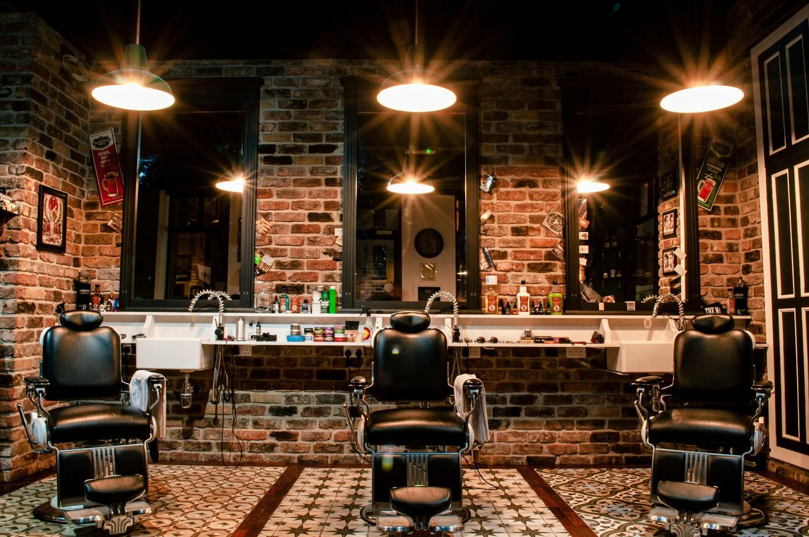 Warm barbershop with leather chairs, brick walls and pendant lights