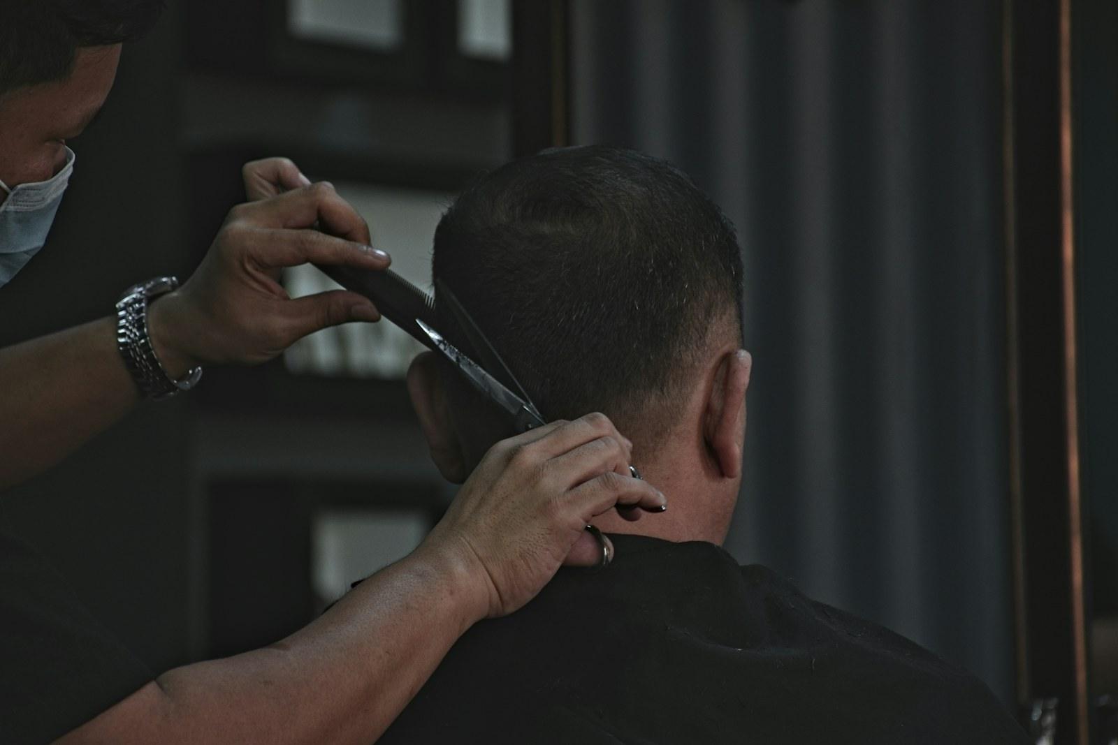 Barber cutting a skin fade with clippers