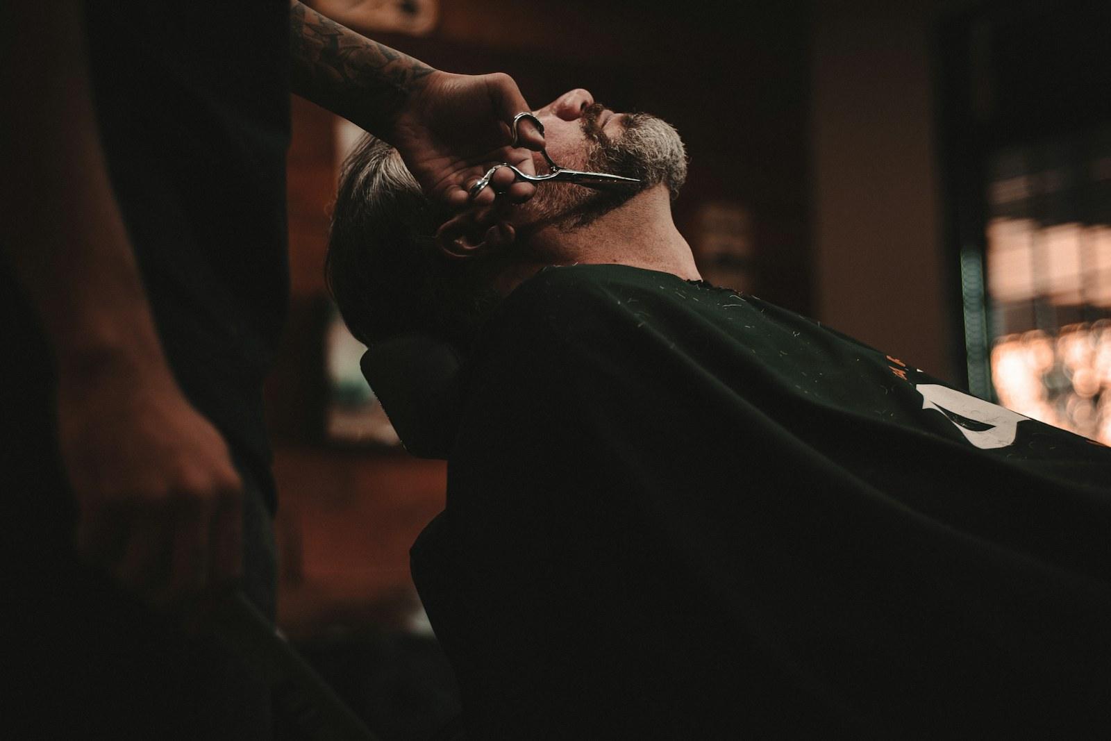 Client relaxing under a straight razor shave