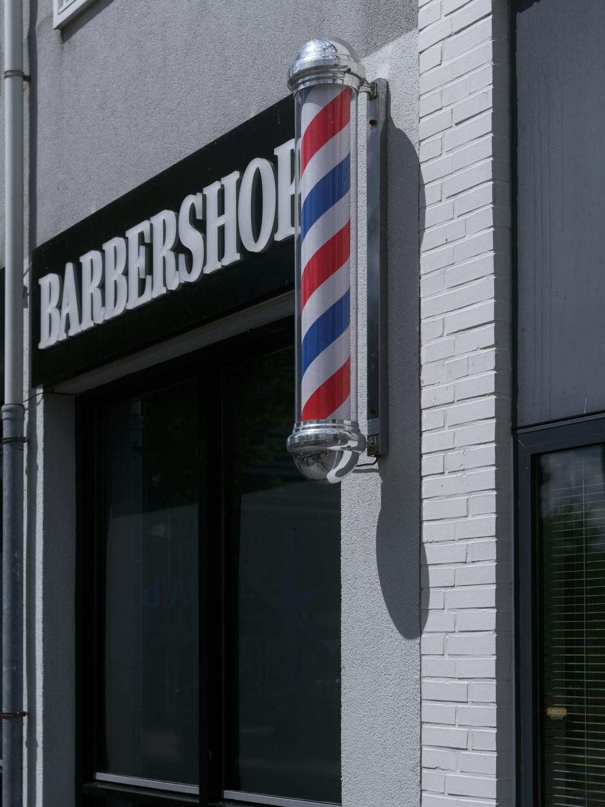 The barbershop storefront with its striped pole